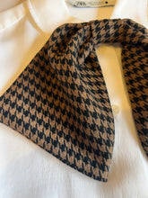 Load image into Gallery viewer, Houndstooth clip on button cover scarf in brown and black close up on shirt