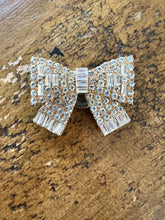 Load image into Gallery viewer, Gold bow shaped diamonte button cover single on table