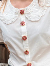 Load image into Gallery viewer, Close up of striking jewellery, button covers on blouse.