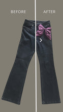 Load and play video in Gallery viewer, video showing the before and after of a plain pair of jeans transformed by pinning two purple silk bows on the pockets
