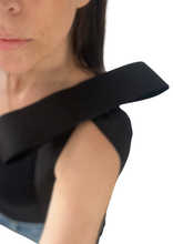 Load image into Gallery viewer, Close-up of a model wearing a black top with a structured silk bow brooch pinned at shoulder on white background.
